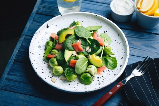 Salad with red fish, avocado and Brussels cabbage