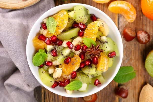 Fruit salad of tangerines, banana and kiwi