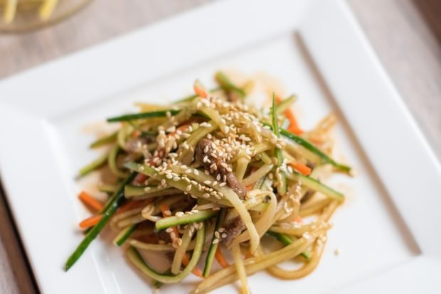 Korean salad with noodles, beef and cucumbers