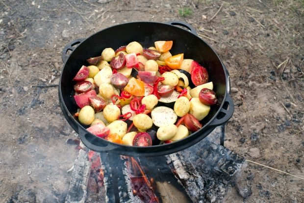 Vegetable stew in a cauldron on a stake